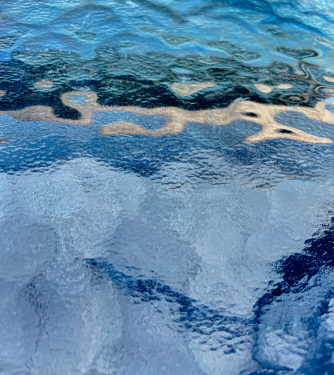 Sky reflected on glass table by Richard Atkinson Sky reflected on glass table