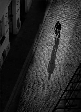 A Cyclist And Their Shadow