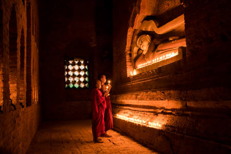 Praying In Front Of Buddha